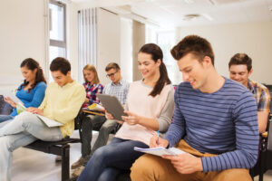 group of smiling students with tablet pc